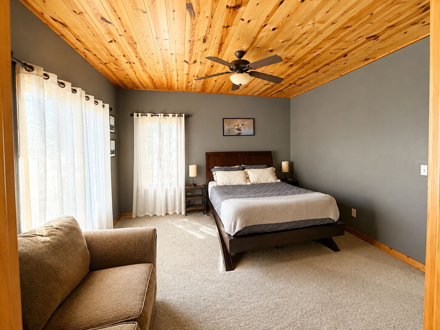 Spacious bedroom with a comfortable bed and sitting area gives guests extra room to relax and settle in.
