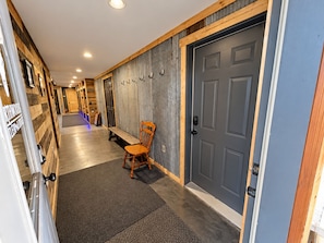 Step inside to a secure smart-lock entrance leading into the lodge living area, with a long interior hallway providing convenient access through to the attached garage. - State ATV Trail|Updated|Wildlife|Trailer Parking (Birchwood)