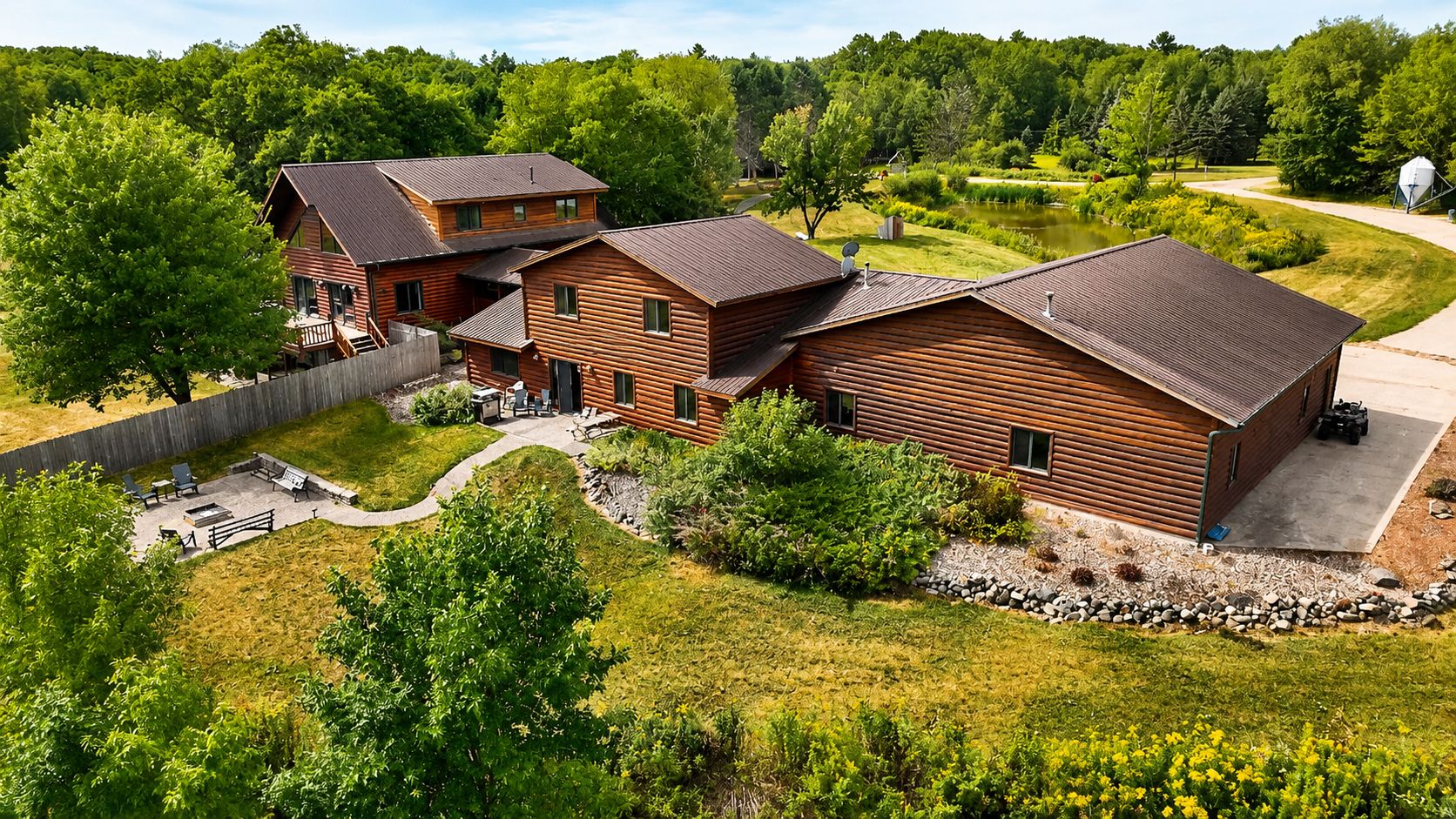 A log cabin with a deck and outdoor seating area.