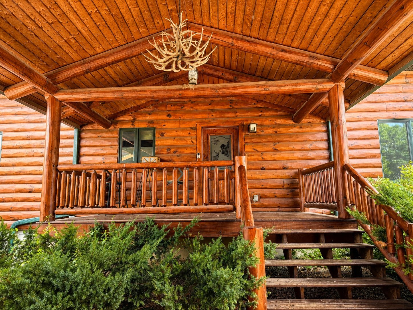 The covered entry porch adds a cozy cabin feel and creates a welcoming transition into the House.