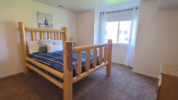 Bright bedroom with rustic log bed and plenty of natural light