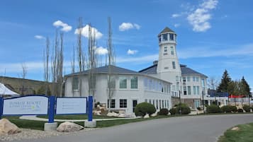 A resort center with a prominent tower, multiple windows, and a signboard indicating amenities like condos and event spaces.