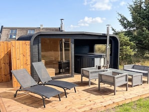 An outdoor hot tub area with lounge chairs and a wooden deck. - 6 Person Holiday Home in Blavand (Blavand)