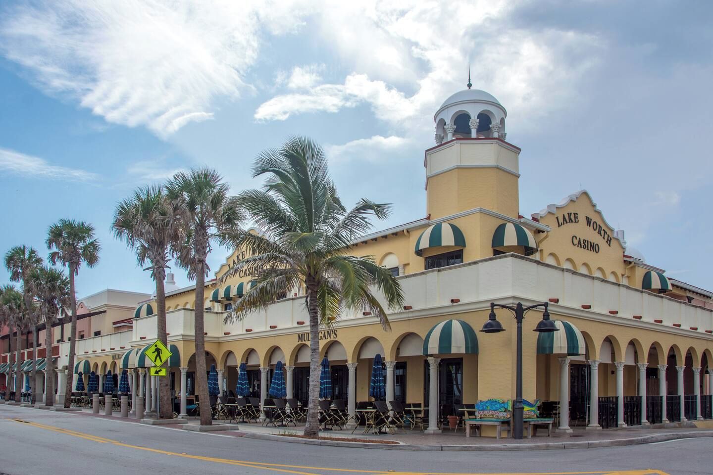 Un bâtiment doté d’un dôme imposant et de fenêtres en arc de cercle, portant l’inscription « Lake Worth Casino ».