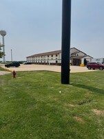 A building with a flat roof and a parking lot.