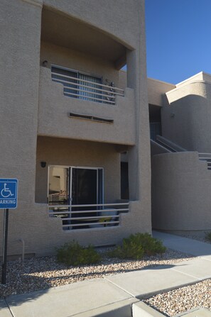 A multi-story building with a parking sign indicating handicapped parking. - Peaceful Laughlin Oasis - First Floor- No Stairs (Laughlin)
