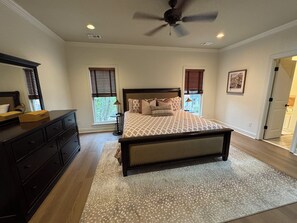 A bedroom with a bed, dresser, windows, and a ceiling fan. - Aspen Bend, a five bedroom retreat close to campus and town. (Oxford)