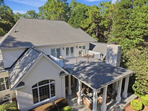 Covered back patio and private balcony overlooking the wooded backyard. - 6BR w/ 12 Beds - Golf Sim, Poker Room & Putting Green in Pinehurst (Pinehurst)