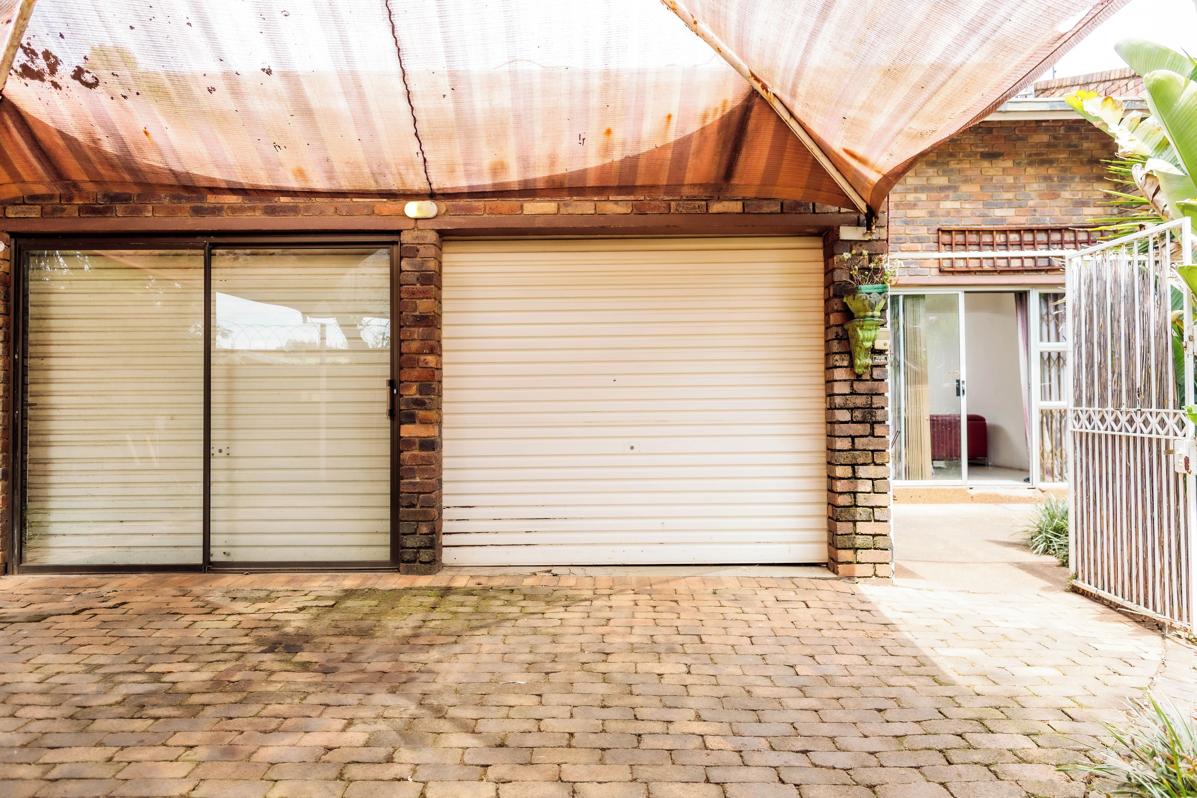 A closed storefront with a metal awning and brick walls.