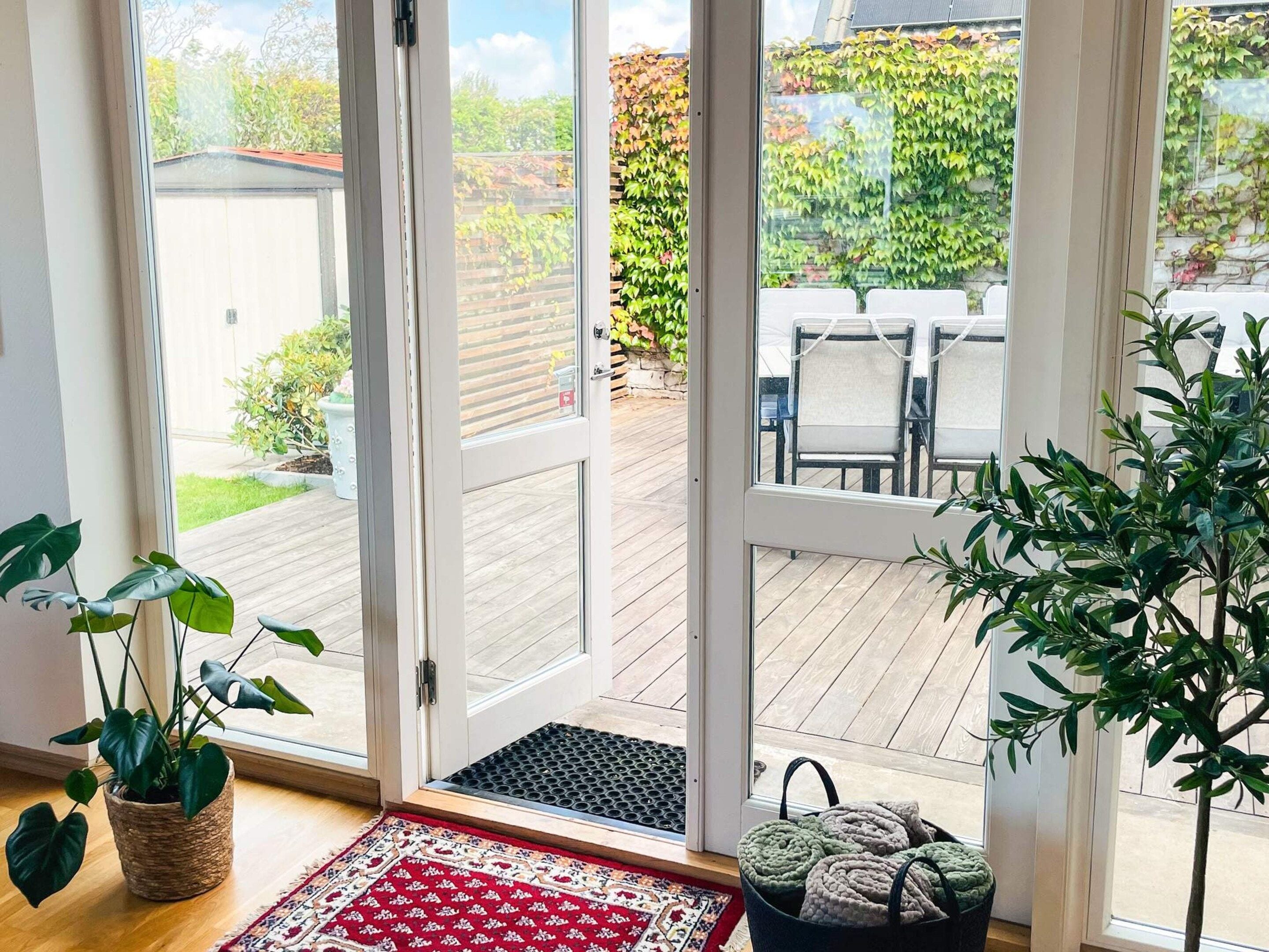 A room with a sliding glass door leading to an outdoor deck.