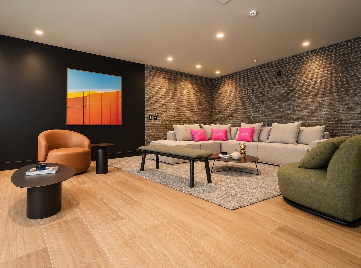 A modern living room with a brick wall, a sofa set, a coffee table, and a single chair.