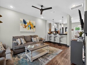 A modern living room with a sofa, coffee table, and artwork on the wall. - 2 Bedroom 2.5 Bath College Station Condo (College Station)