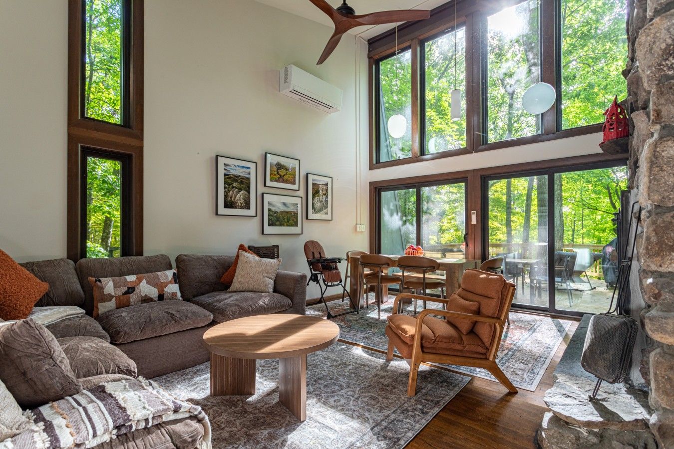 Surrounded by towering trees and natural light, this living room is made for relaxing