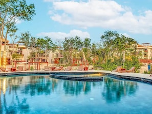 A swimming pool with lounge chairs and a clear sky. - Jungle Retreat with 2 Pools & Cenotes in vibrant Tulum (Tulum)