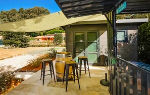 An outdoor seating area with a table, stools, and a barrel. - Cozy home in Cheval-Blanc with private swimming pool, can be inside or outside (Cheval-Blanc)