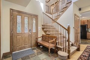 A wooden staircase with a bench at the bottom, leading to a second floor. - Beautiful 3 Bedroom + Den Townhome in Breckenridge, Colorado (Breckenridge)