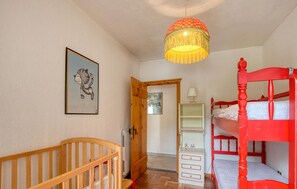 A child's room with a bunk bed, a wooden crib, a hanging lamp, and a framed picture on the wall. - 2 bedroom awesome apartment in Santo Stefano D'Aveto (Santo Stefano D'Aveto)