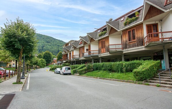 A row of traditional chalet-style buildings with balconies, a clear road, and a mountain backdrop. - 2 bedroom awesome apartment in Santo Stefano D'Aveto (Santo Stefano D'Aveto)