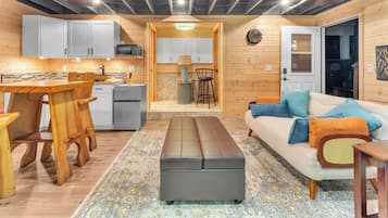 A compact living space with a kitchen, dining area, and seating area.