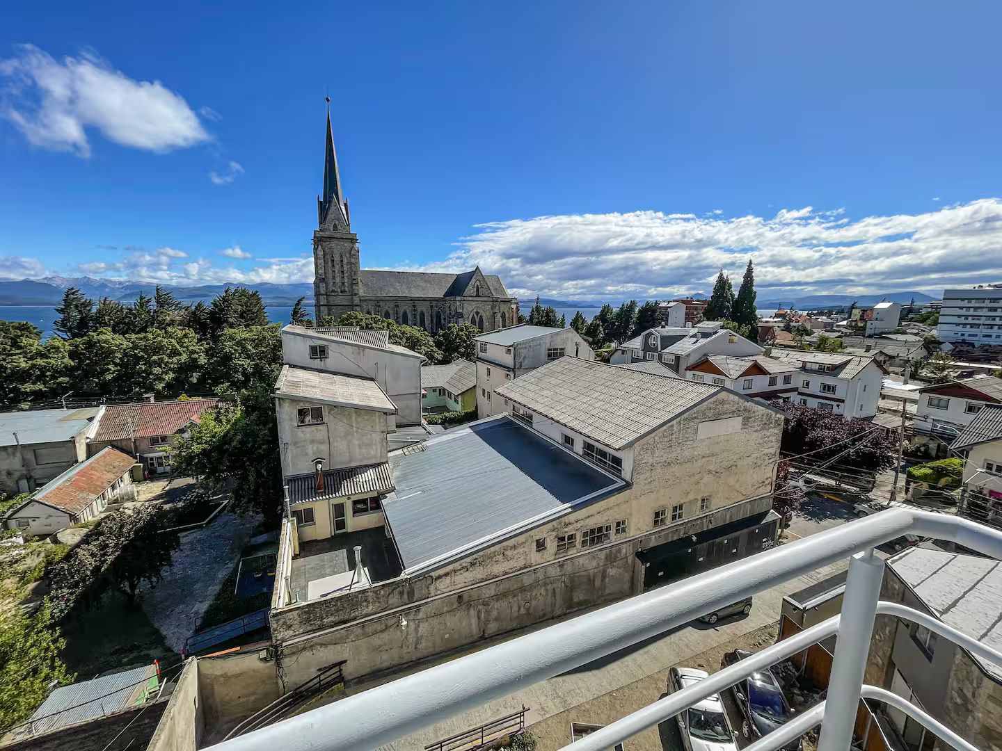 A view of a town with a prominent church and residential buildings.