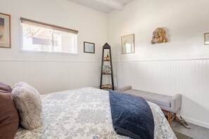 A bedroom with a bed, a bench, a ladder, and a wall-mounted shelf. - Cowboy Tubs, Quiet, Zen, Stars-1 bd + Studio (Joshua Tree)