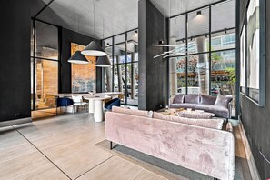 A modern interior with a dining area, seating, and large windows. - Modern 2BR in Santiago - A/C • Parking • Great Location (Santiago)