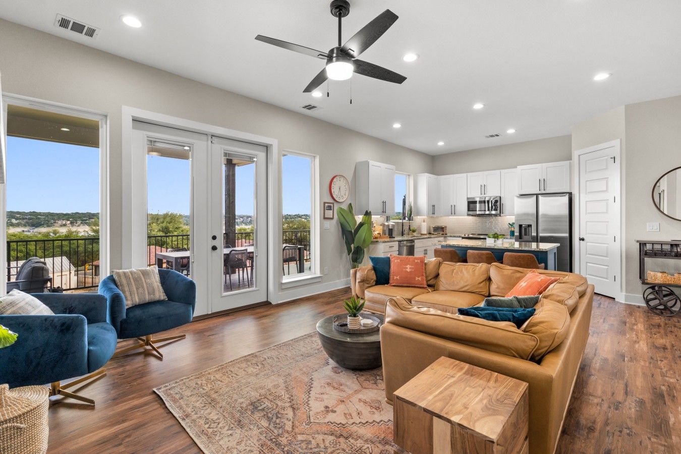 A spacious living area with a sofa, a coffee table, and a view of the outdoors.