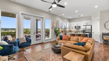 A spacious living area with a sofa, a coffee table, and a view of the outdoors.