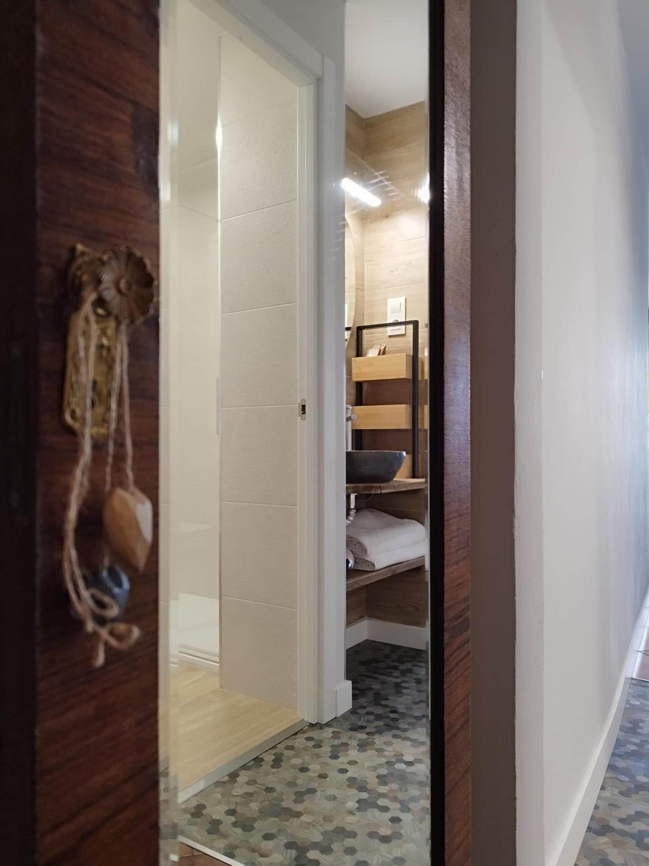Acceso al baño privado desde la zona de descanso, con toallas de algodón