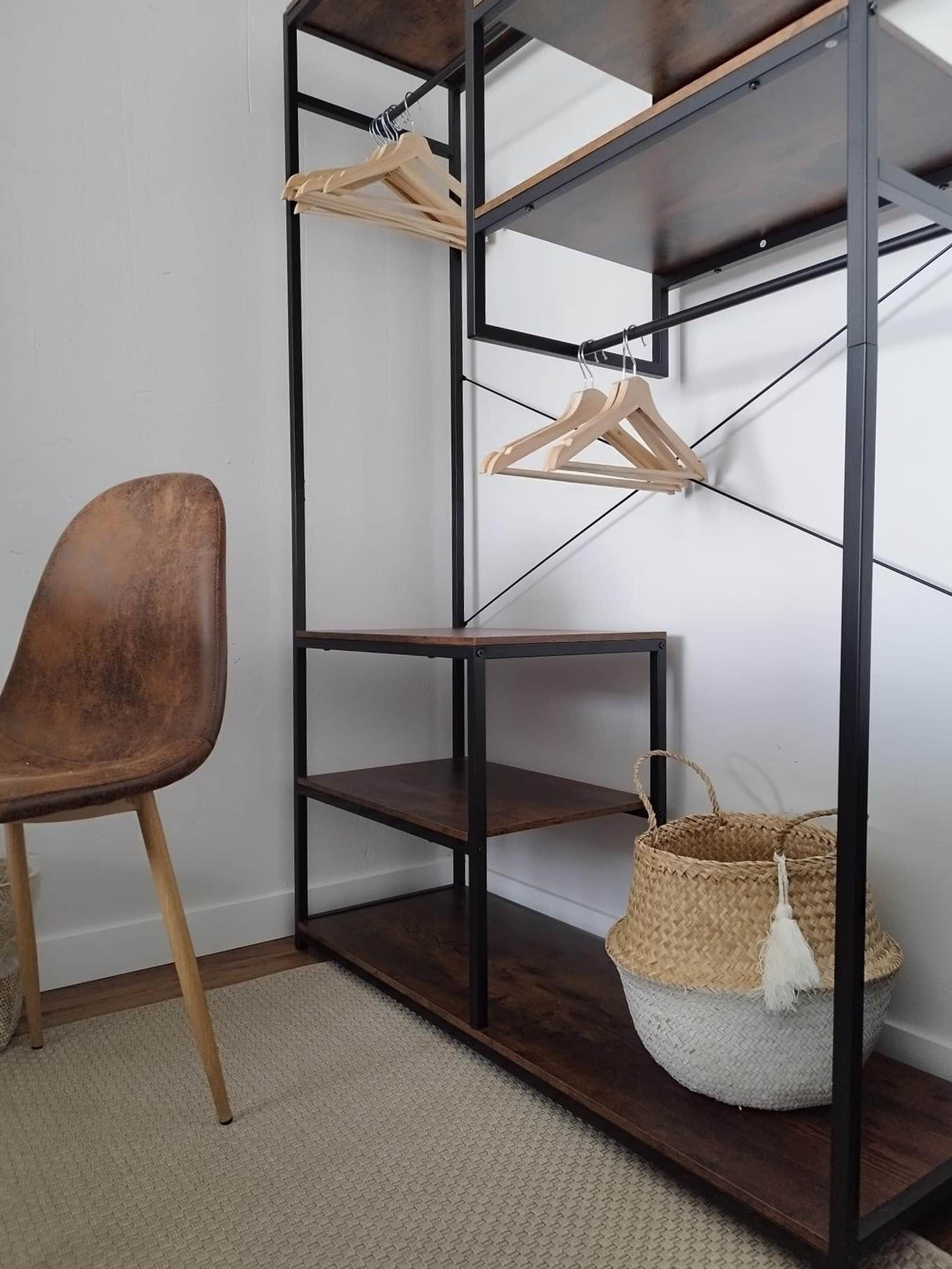 A corner of a room with a metal shelving unit, a brown chair, and a woven basket.