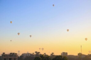 A clear sky with multiple hot air balloons.
