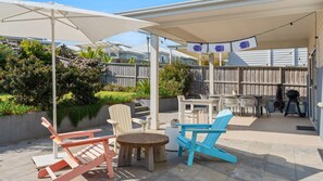 An outdoor patio with a covered seating area, a grill, and a pool. - Catherine Hill Bay - Ocean Views & Coastal Living (Catherine Hill Bay)