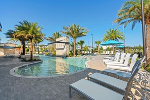 A pool area with lounge chairs and palm trees. - Stunning 6BR, Private Pool, Prime Location (Orlando)