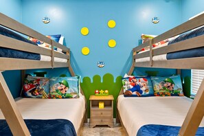 A children's bedroom with bunk beds, Mario-themed bedding, and a green wall with yellow circles. - Stunning 6BR, Private Pool, Prime Location (Orlando)