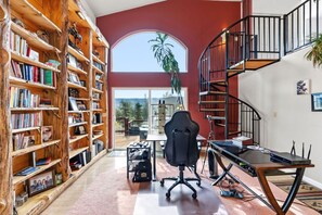 A library with bookshelves, a desk with a chair, and a spiral staircase. - Sweet Home Colorado!!!! Where the skies are Crystal Blue!!!! (Kremmling)