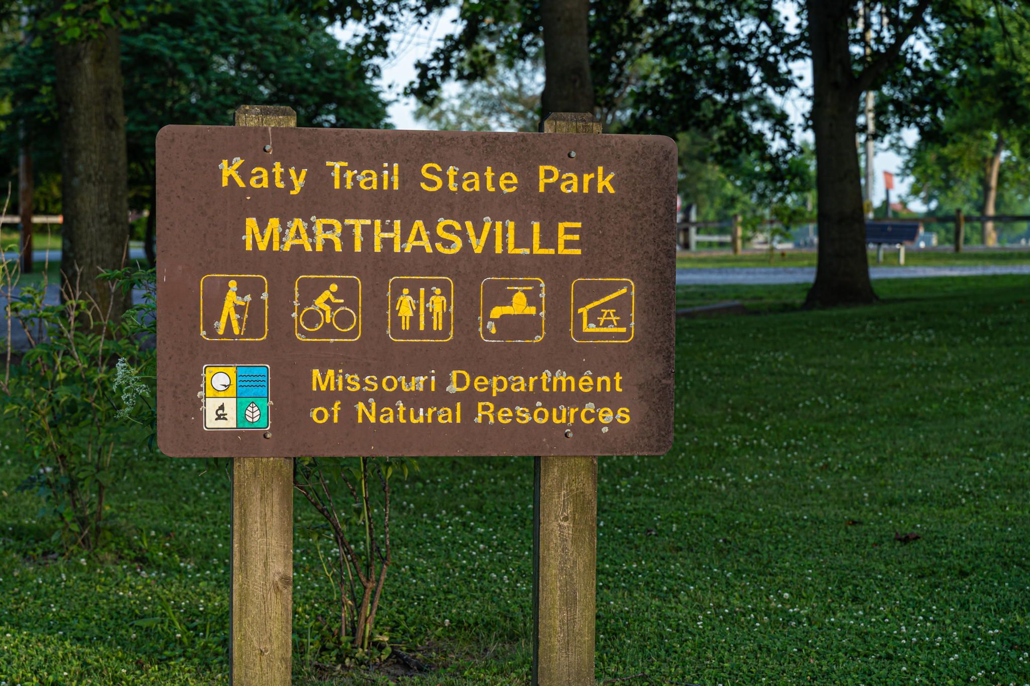 A sign for Katy Trail State Park in Marthaville, Missouri, indicating hiking, biking, and camping activities.