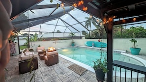 A covered outdoor pool area with a glass ceiling, lounge seating, and potted plants. - Gated/ 2 Master Bed / 2.5 bath/ Private Screened in Pool-10min from Bonita Beach (Bonita Springs)