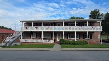 A two-story building with a balcony, a staircase, and a sign that reads 'Blue Moon'.