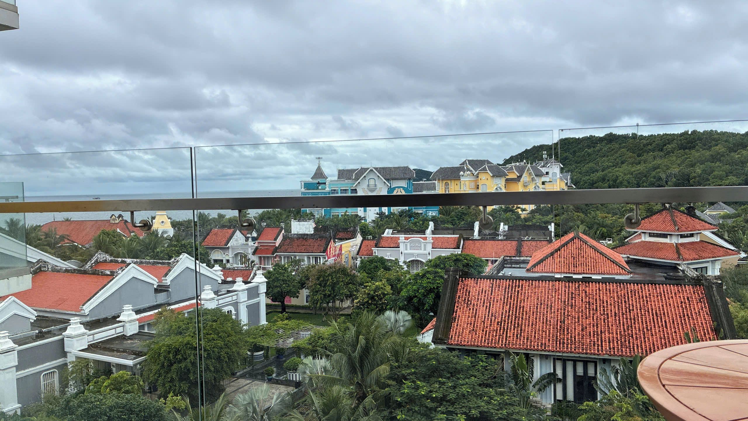 A residential area with red-tiled roofs and a variety of building styles, including colonial and modern architecture.