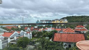 A residential area with red-tiled roofs and a variety of building styles, including colonial and modern architecture.