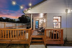 A house with a wooden deck, a barbecue grill, and a brick exterior. - The Amelia @ Coler Creek: Private Hot Tub > Fire Pit > Bikers Lounge (Bentonville)