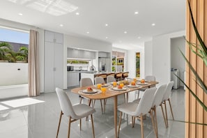 Spacious dining area featuring a full-size table with seating for eight, ideal for group meals and gatherings. - Brand New 3BR Villa | Pool, BBQ & Lighthouse View (Noord)
