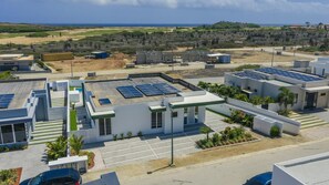Aerial view highlighting the full property footprint, private layout, and serene surrounding neighborhood. - Brand New 3BR Villa | Pool, BBQ & Lighthouse View (Noord)