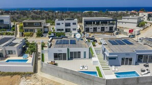 Aerial view highlighting the full property footprint, private layout, and serene surrounding neighborhood. - Brand New 3BR Villa | Pool, BBQ & Lighthouse View (Noord)