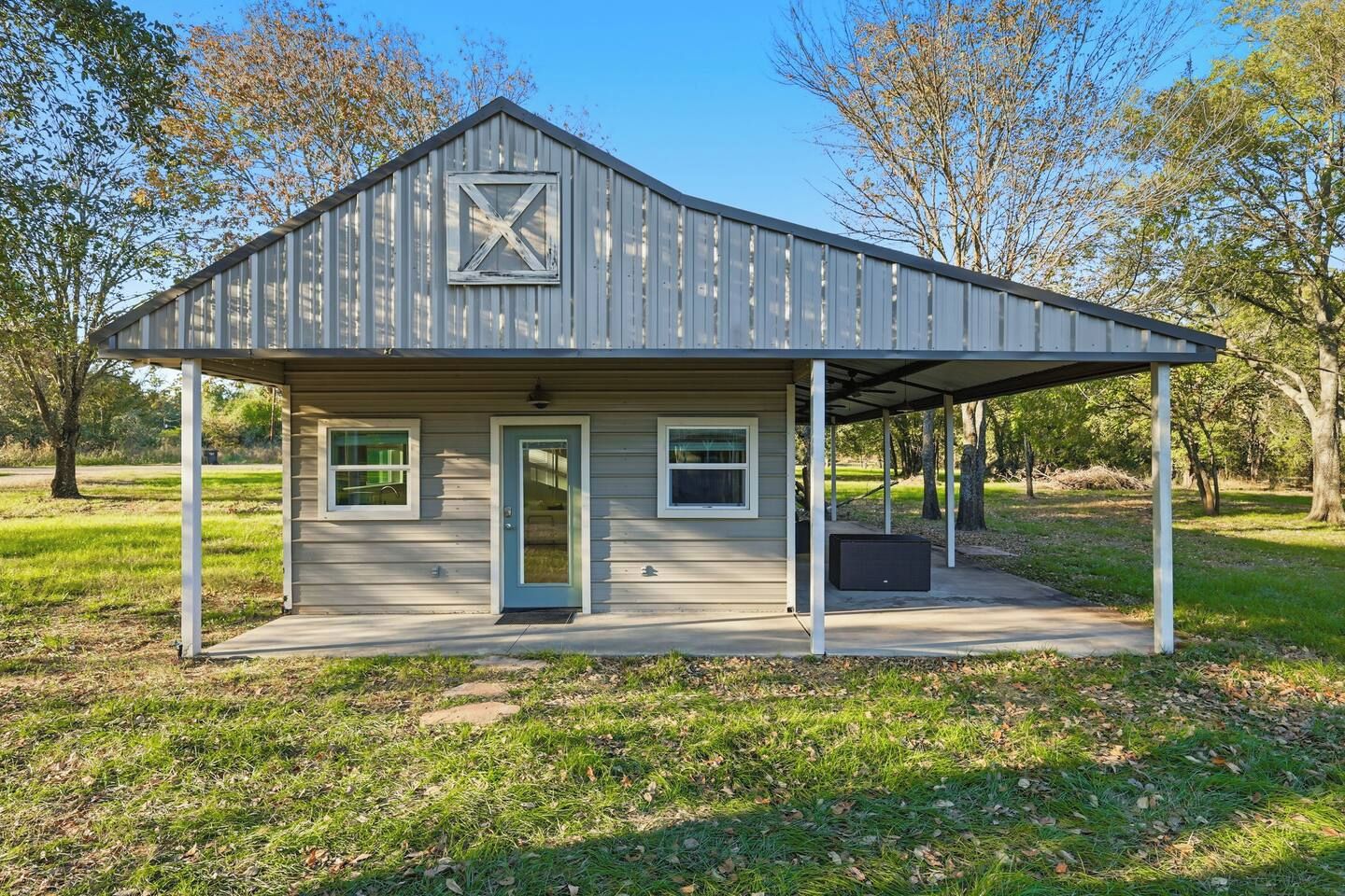 A single-story building with a gabled roof and a covered porch.