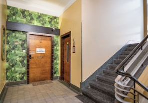 A hallway with a wooden door labeled 'Hostel Moderna-Rest' and a staircase with a metal handrail. - Hostel Moderna Rest Room 1 (Katowice)
