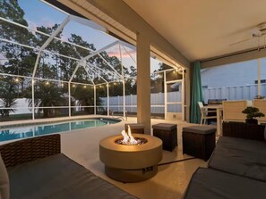 Screened private pool lanai with cozy fire table and outdoor lounge - NEW! Heated Pool, Fire Pit, Near Beaches, Dining (Palm Coast)