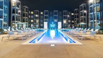 A hotel pool area with lounge chairs and a sign reading 'PALMER HOUSE.'