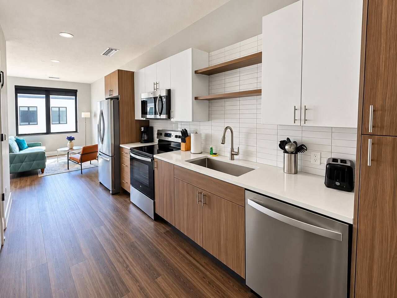 A modern kitchen with wooden cabinets, stainless steel appliances, and a white countertop.