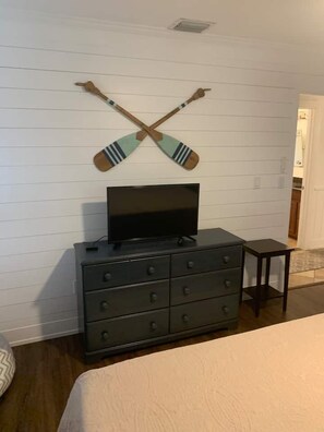 A bedroom with a bed, a dresser, a television on top of the dresser, and two crossed paddles on the wall. - 2 Mi to Beach! Pool, Hot Tub, 2 Tiki Bars, Pets OK (Bonita Springs)